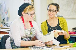 A Teacher and Teacher's Aide working together on an art artivity